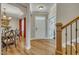 Inviting foyer with hardwood floors, a dining room view and a staircase at 8304 Rosiere Dr, Cary, NC 27518