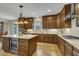 Spacious kitchen with custom cabinets, a center island, stainless appliances, and wood floors at 8304 Rosiere Dr, Cary, NC 27518