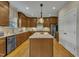 Spacious kitchen featuring wooden cabinets, a center island, and stainless steel appliances at 8304 Rosiere Dr, Cary, NC 27518