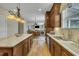 Beautiful kitchen with custom cabinets, granite countertops, stainless appliances, and wood floors at 8304 Rosiere Dr, Cary, NC 27518