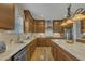Kitchen with light-colored countertops, wooden cabinets, and modern stainless-steel appliances at 8304 Rosiere Dr, Cary, NC 27518