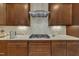Well-equipped kitchen features a gas cooktop, custom cabinets, and stone countertops at 8304 Rosiere Dr, Cary, NC 27518