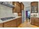 Modern kitchen featuring stainless appliances, custom cabinets, granite countertops, and tile backsplash at 8304 Rosiere Dr, Cary, NC 27518