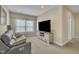 Comfortable living room features a modern media console and large windows that let in natural light at 8304 Rosiere Dr, Cary, NC 27518