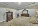 This main bedroom features a tray ceiling, chandelier, and elegant furniture at 8304 Rosiere Dr, Cary, NC 27518