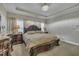 This main bedroom features a tray ceiling, chandelier, and elegant furniture at 8304 Rosiere Dr, Cary, NC 27518