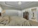 This main bedroom features a tray ceiling, chandelier, and elegant furniture at 8304 Rosiere Dr, Cary, NC 27518