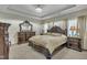 This main bedroom features a tray ceiling, chandelier, and elegant furniture at 8304 Rosiere Dr, Cary, NC 27518
