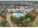 Community pool and recreation area surrounded by trees, playground, and walking path at 8304 Rosiere Dr, Cary, NC 27518