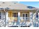 A welcoming balcony featuring white railings and a ceiling fan with double doors at 833 Providence Glen Dr, Chapel Hill, NC 27514