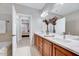 Bathroom with double sinks, quartz counters, wood cabinets, and tiled shower/tub at 833 Providence Glen Dr, Chapel Hill, NC 27514