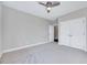 Carpeted bedroom with ceiling fan and double door closet at 833 Providence Glen Dr, Chapel Hill, NC 27514