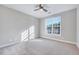 Bright carpeted bedroom featuring a ceiling fan and large window at 833 Providence Glen Dr, Chapel Hill, NC 27514