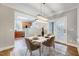 Elegant dining room featuring modern furnishings, ample natural light, and an open layout to kitchen at 833 Providence Glen Dr, Chapel Hill, NC 27514