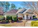 Exterior shot of a charming community clubhouse with well-maintained landscaping at 833 Providence Glen Dr, Chapel Hill, NC 27514