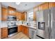 Well-equipped kitchen featuring stainless steel appliances, light countertops, and wood-stained cabinetry at 833 Providence Glen Dr, Chapel Hill, NC 27514