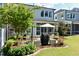 Landscaped backyard with patio furniture, grill, and lush greenery for outdoor enjoyment at 938 Haybeck Ln, Apex, NC 27523