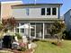 Backyard featuring a covered patio area, outdoor seating, and lush landscaping for relaxing at 938 Haybeck Ln, Apex, NC 27523