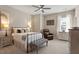 Cozy bedroom featuring a wrought iron bed frame, comfortable seating, and ample natural light at 938 Haybeck Ln, Apex, NC 27523
