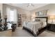 Comfortable bedroom with a large bed, decorative pillows, and a cozy chair at 938 Haybeck Ln, Apex, NC 27523
