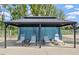 Outdoor cabana with lounge chairs, providing a comfortable and private relaxation space at 938 Haybeck Ln, Apex, NC 27523