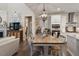 Dining area with wood table and chairs, decorative lighting, and an open view to the kitchen at 938 Haybeck Ln, Apex, NC 27523