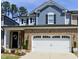 Charming two-story home featuring a brick facade, two-car garage, and well-maintained landscaping at 938 Haybeck Ln, Apex, NC 27523