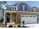 Charming two-story home featuring a brick facade, two-car garage, and well-maintained landscaping at 938 Haybeck Ln, Apex, NC 27523