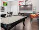 Spacious game room with a pool table, wet bar, and custom card-themed wall art at 938 Haybeck Ln, Apex, NC 27523