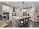 Well-lit kitchen with a large center island, stainless steel appliances, and modern lighting at 938 Haybeck Ln, Apex, NC 27523