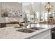 Granite kitchen island with stainless steel faucet and sink and decorative accents at 938 Haybeck Ln, Apex, NC 27523