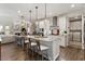 Bright kitchen features a center island with granite countertops and stainless steel appliances at 938 Haybeck Ln, Apex, NC 27523