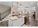 Kitchen island with granite countertops and stainless steel appliances with nearby staircase at 938 Haybeck Ln, Apex, NC 27523