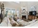 Comfortable living room with modern decor, a fireplace, and views to the outside at 938 Haybeck Ln, Apex, NC 27523