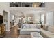 Second floor view of spacious living room with large sectional sofa and fireplace at 938 Haybeck Ln, Apex, NC 27523