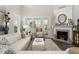 Bright living room with fireplace and lots of natural light from a bank of windows at 938 Haybeck Ln, Apex, NC 27523