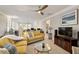 Upstairs living room offers a cozy and relaxing space with ceiling fan and a great view at 938 Haybeck Ln, Apex, NC 27523