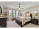 Spacious main bedroom with ceiling fan, decorative curtains, and ample natural light at 938 Haybeck Ln, Apex, NC 27523