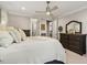Neutral main bedroom with a ceiling fan, dressers for storage, and crown molding at 938 Haybeck Ln, Apex, NC 27523