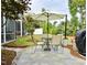 Outdoor patio area with dining table, chairs, umbrella, and well manicured yard at 938 Haybeck Ln, Apex, NC 27523
