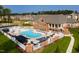 Community pool area featuring ample seating, cabanas, and lush landscaping at 938 Haybeck Ln, Apex, NC 27523
