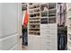 Organized walk-in closet with shelving, drawers, and hanging rods for storage at 938 Haybeck Ln, Apex, NC 27523