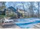 View of covered pool with home and sunroom in background at 94 Cedar Hills Cir, Chapel Hill, NC 27514