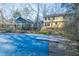 A backyard featuring a closed pool and house that backs up to a wooded area at 94 Cedar Hills Cir, Chapel Hill, NC 27514