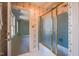 Bathroom view with floral wallpaper, blue tile shower and a view into the bedroom at 94 Cedar Hills Cir, Chapel Hill, NC 27514