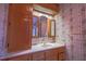 Traditional bathroom with a wood vanity, white countertop, and floral wallpaper at 94 Cedar Hills Cir, Chapel Hill, NC 27514