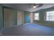 Bedroom featuring green walls, carpet, and two windows with shutters at 94 Cedar Hills Cir, Chapel Hill, NC 27514