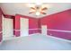 Bedroom with two closets, gray carpet, white trim, and ceiling fan with light fixture at 94 Cedar Hills Cir, Chapel Hill, NC 27514