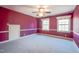 Bedroom with two windows, gray carpet, and a ceiling fan with a light fixture at 94 Cedar Hills Cir, Chapel Hill, NC 27514
