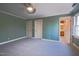 Bedroom featuring green walls, carpet, and view into a bathroom at 94 Cedar Hills Cir, Chapel Hill, NC 27514